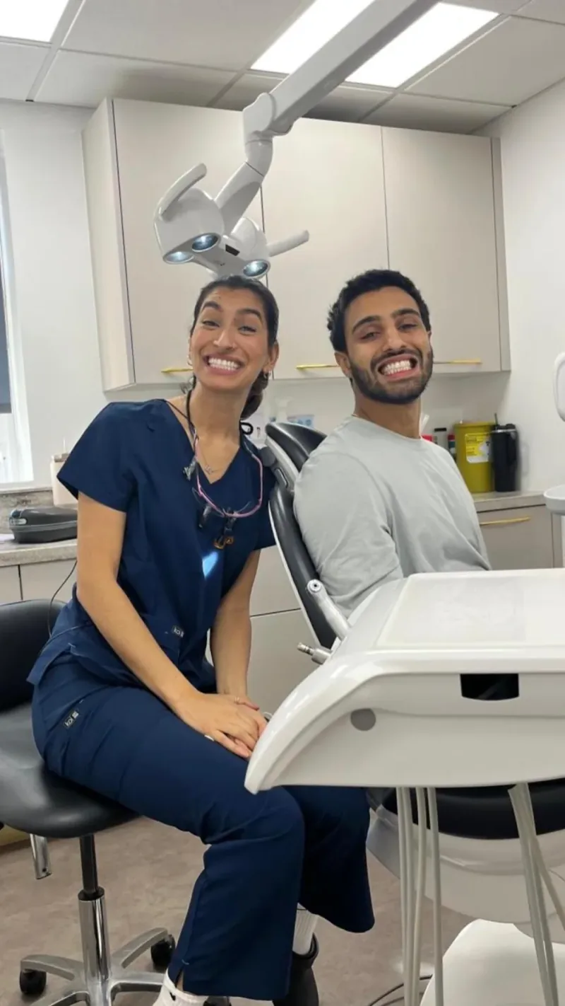 Dr Deesha and a patient grinning side by side in the surgery