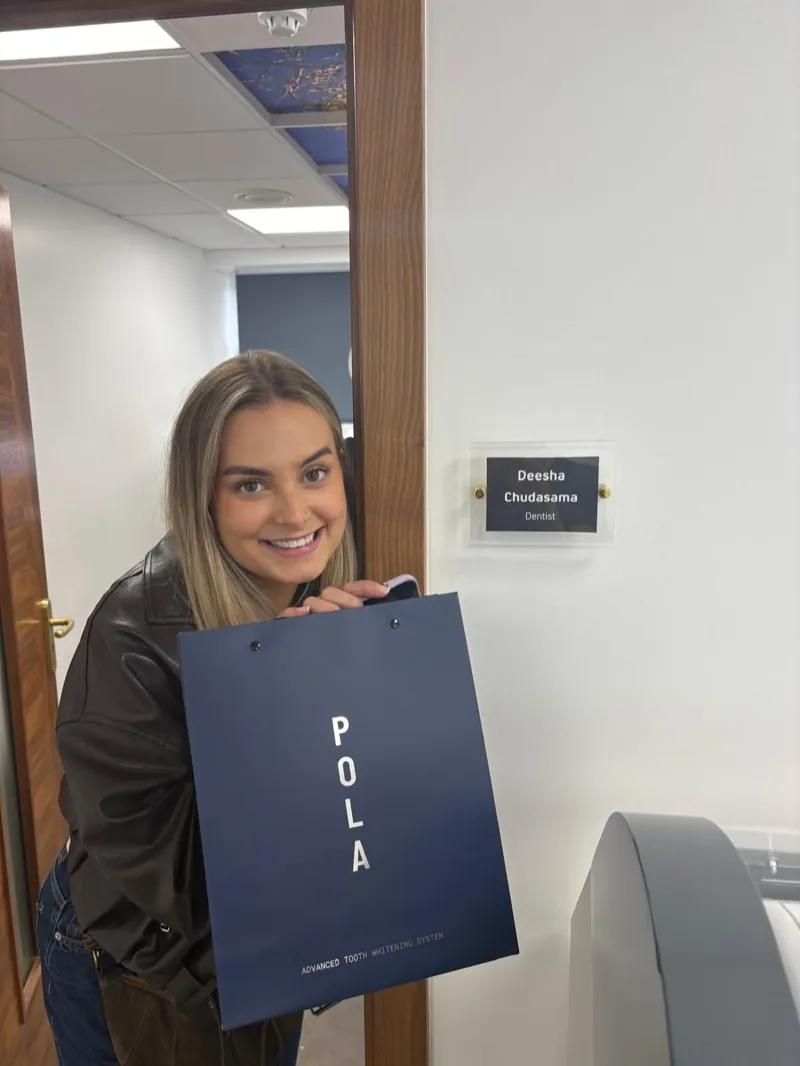 A patient at the surgery door collecting a whitening kit